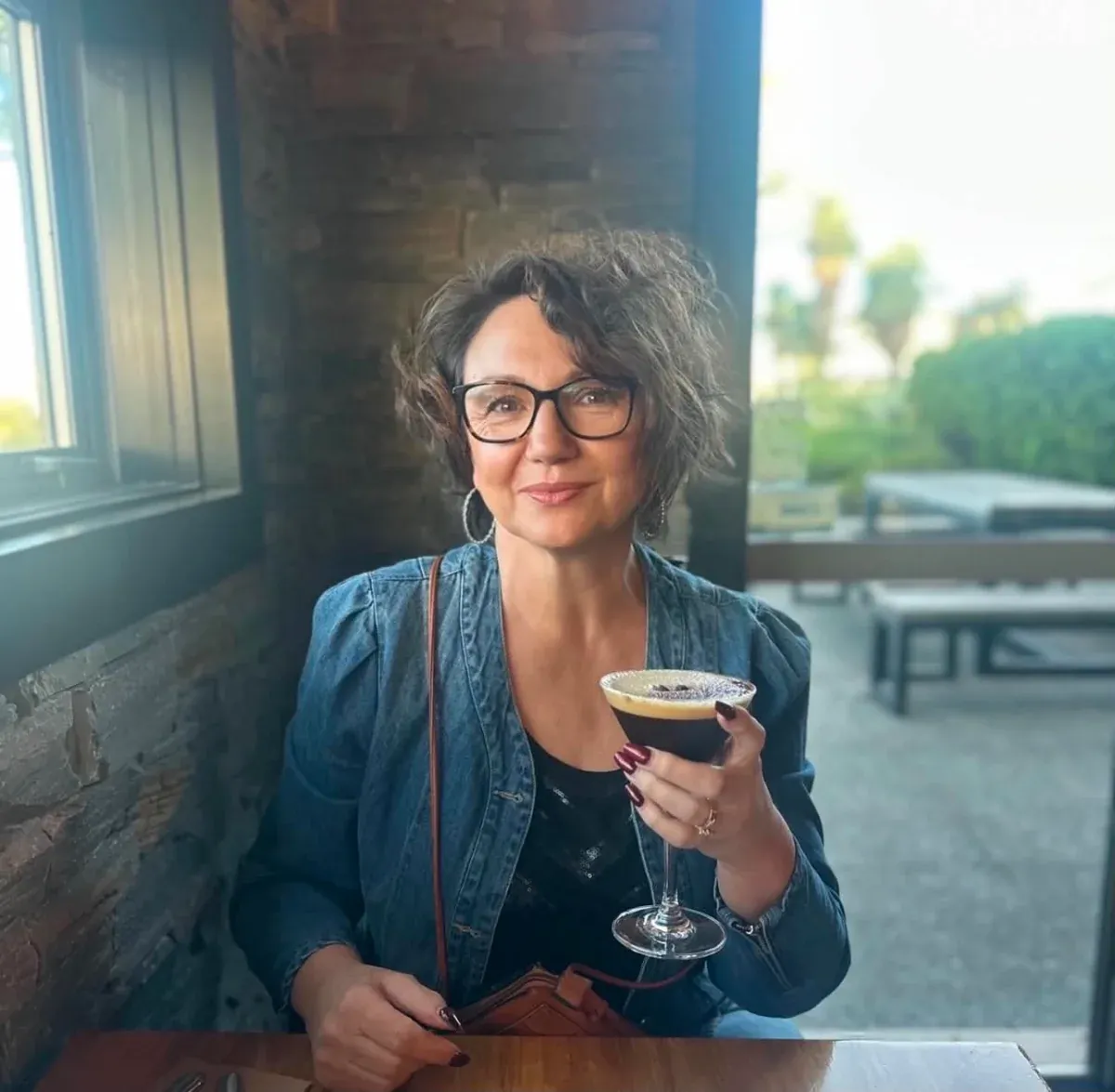 Lea-Anne relaxing with a drink, ready for a first chat about your wedding ceremony
